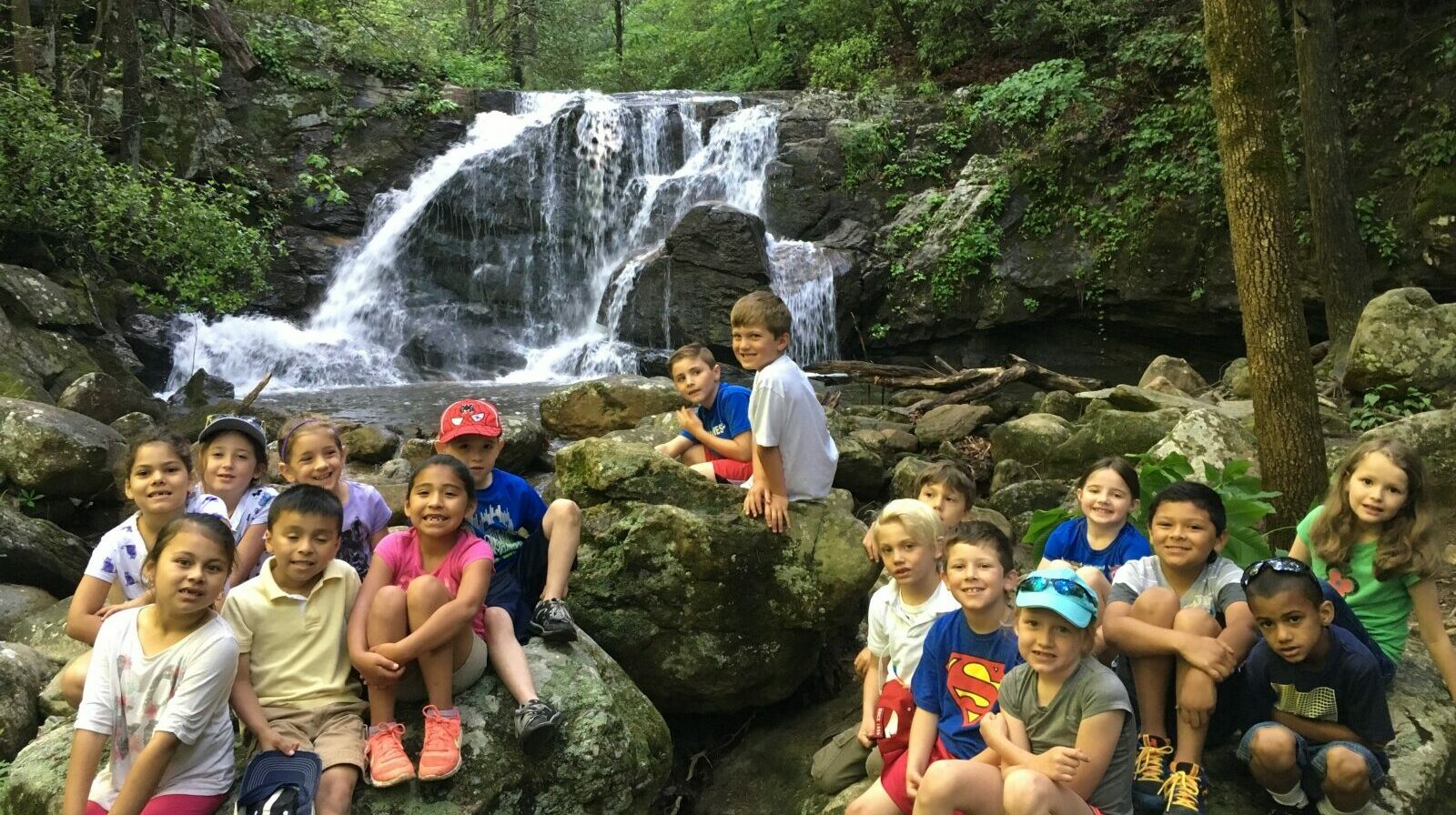 Children enjoying a waterfall near Bright's Creek