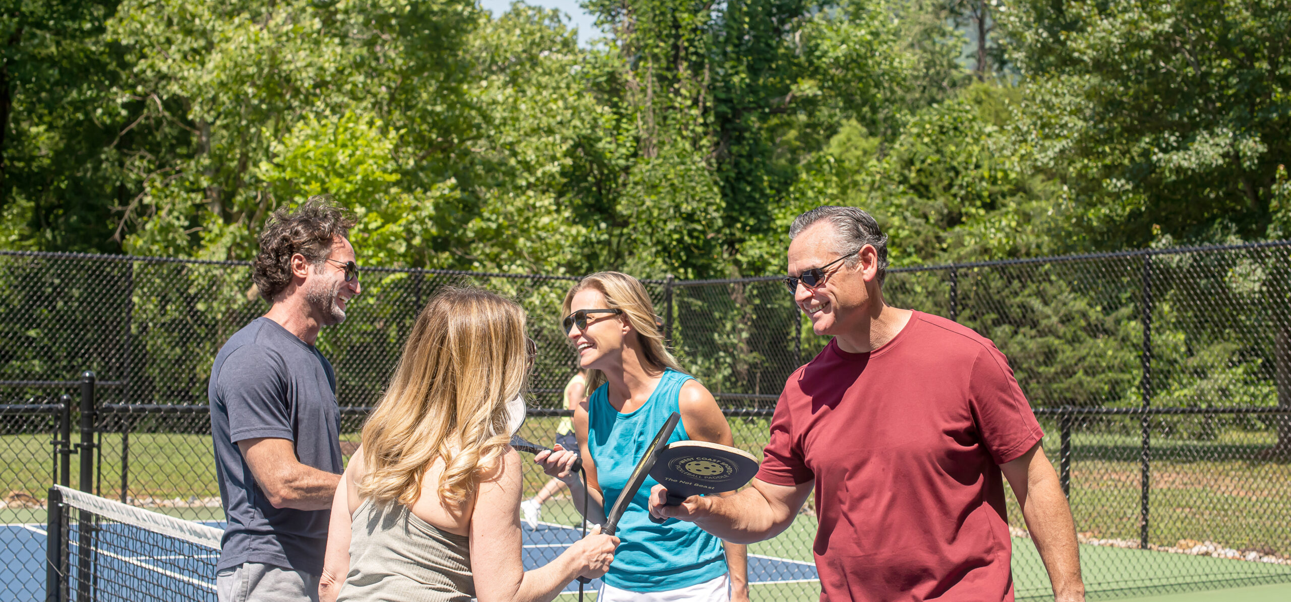 group of four play pickleball